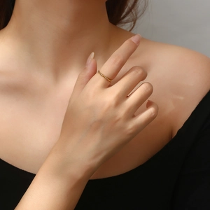 Detail of adjustable gold bamboo joint ring worn elegantly on a model's finger