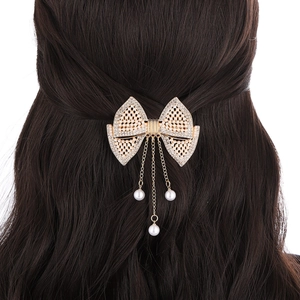 Elegant gold bow hair clip with sparkling rhinestones and dangling pearl tassels for women