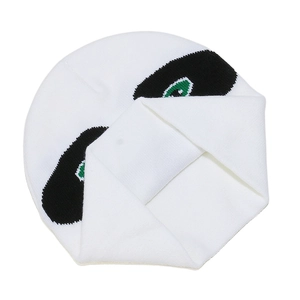 Detail of white knitted beanie featuring green and black embroidered eye patterns