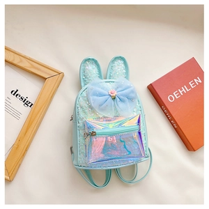 Detail of light blue sequined kids backpack with rabbit ears and a colorful tulle bow