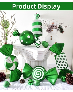 Close-up of assorted green and white Christmas candy ornaments on a festive display
