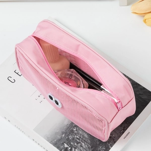 Detail of pink mesh makeup bag featuring signature embroidered eyes and zipper