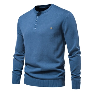 Detail of blue men's knitted sweater featuring a four-button Henley neckline texture