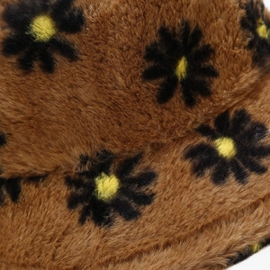 Close-up of brown plush bucket hat showing daisy embroidery and soft faux fur texture