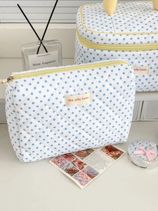 Quilted cotton lemon dot makeup bag detail with yellow zipper and brand logo