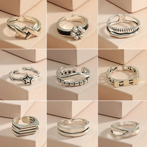 9-piece set of silver minimalist open rings featuring geometric and floral designs