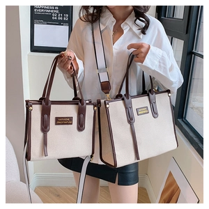 Comparison of two sizes for this canvas tote bag with brown leather trim and shoulder strap
