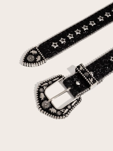 Close-up of black glitter belt with silver star studs and western floral carved buckle