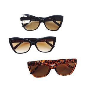 Retro cat eye sunglasses set in black and tortoise frames with gradient lenses