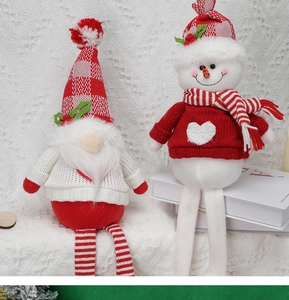 Detailed view of plush Christmas gnome dolls with knitted hats and long dangling legs