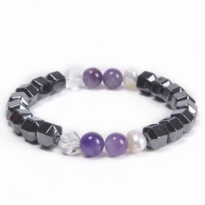 Macro detail of natural freshwater pearls, purple crystals, and hematite beads bracelet
