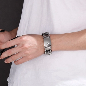 Close-up of men's vintage leather cord woven dragon bone bracelet with silver charms