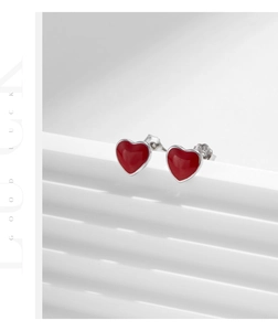 Macro detail of red enamel heart earring showing the S925 sterling silver hallmark stamp