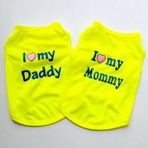 Detail of neon yellow dog vests featuring I love my Mommy and Daddy printed slogans