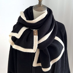 Minimalist black and white knitted scarf with luxury border and leather brand patch