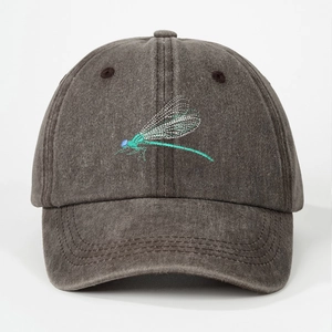 Close-up of detailed dragonfly embroidery on washed cotton baseball cap fabric