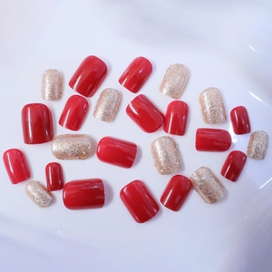 Short square press-on nails set featuring glossy red and champagne gold glitter finishes