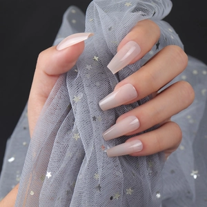 Macro detail of long ballerina nails with glossy nude pink UV coating and sheer finish