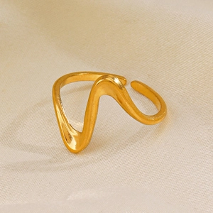 Elegant gold irregular wave open ring on silk background minimalist stainless steel jewelry