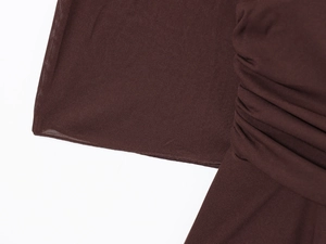 Detailed close-up of dark brown fabric showing stitching quality and ruched design