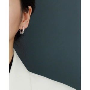 Close-up of S925 sterling silver hoop earrings with chain texture and cubic zirconia