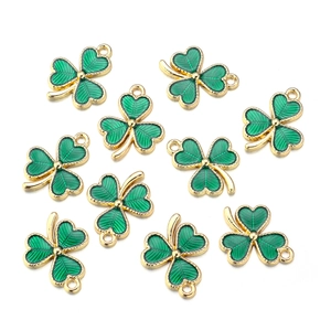 Macro detail of green enamel clover pendants with gold metal edges for DIY jewelry