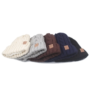 Detail view of five colors and soft faux fleece lining of thick cable knit beanies