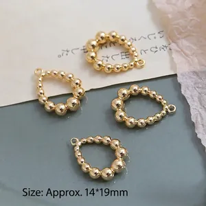 Macro shot of 4 gold plated beaded teardrop charms with dimensions 14x19mm for DIY jewelry