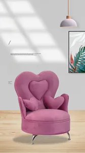 Detailed view of pink velvet sofa-shaped jewelry box with heart-shaped back and metal legs
