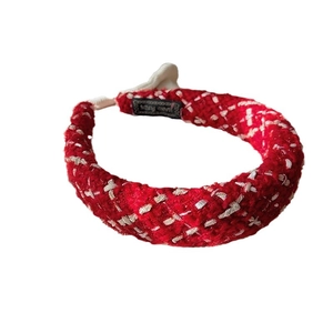Elegant red tweed headband with white knit texture on white background for New Year