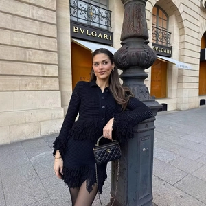 Elegant black knit fringe two-piece set with long sleeve cardigan and midi skirt