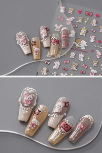 Detailed view of 5D embossed nail stickers featuring cute cartoon animals and pink bows