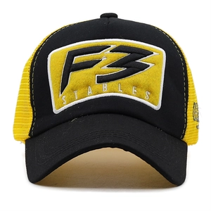 Detail of 3D embroidered F3 patch and yellow breathable mesh on the trucker hat