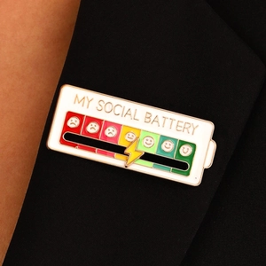 Creative social battery enamel pin with sliding lightning bolt on black blazer lapel