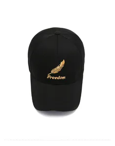 Detail of black mesh baseball cap featuring golden feather embroidery and Freedom text