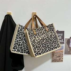 Minimalist leopard print linen tote bags with leather handles shown in a lifestyle scene