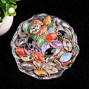Marquise amethyst agate pendants with gold metal edges in a glass tray