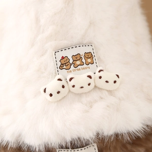 Detail of plush bucket hat featuring soft faux fur texture and three 3D bear ornaments
