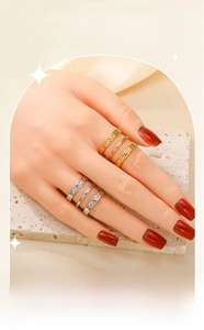 Detail of vintage three-layer embossed gold and silver stainless steel rings with hammered texture