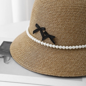 French straw sun hat with pearl chain and double black ribbon bows for elegant summer vacation