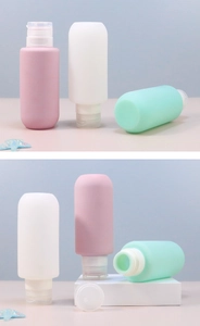 Detailed view of 200ml silicone travel squeeze bottles in pastel pink, white, and mint green.