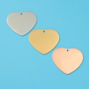 Detailed view of polished heart pendants in silver, gold, and rose gold finishes