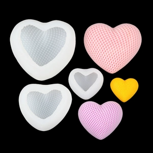 Macro detail of heart-shaped silicone molds showing fine grid texture and finished casts