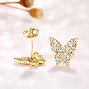 Detail of gold butterfly stud earrings with micro-pave cubic zirconia crystals