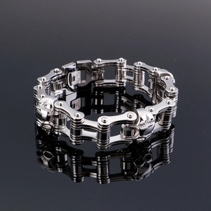 Macro detail of industrial skull link bracelet in polished stainless steel with mirror reflection
