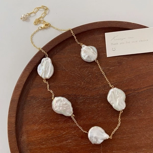 Detailed view of Baroque freshwater pearls on a gold adjustable necklace chain