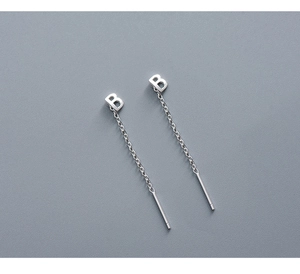 Detail of S999 sterling silver letter B long chain earring thread with polished finish