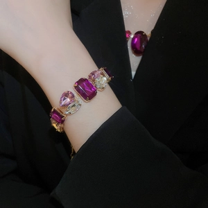 Macro shot of vintage gold bracelet with purple, pink and champagne crystals