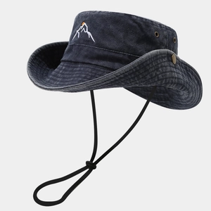 Close-up of hiking hat with mountain embroidery, metal eyelets and adjustable chin cord