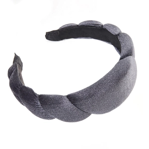 Deep grey padded velvet headband with elegant twisted texture on a white background